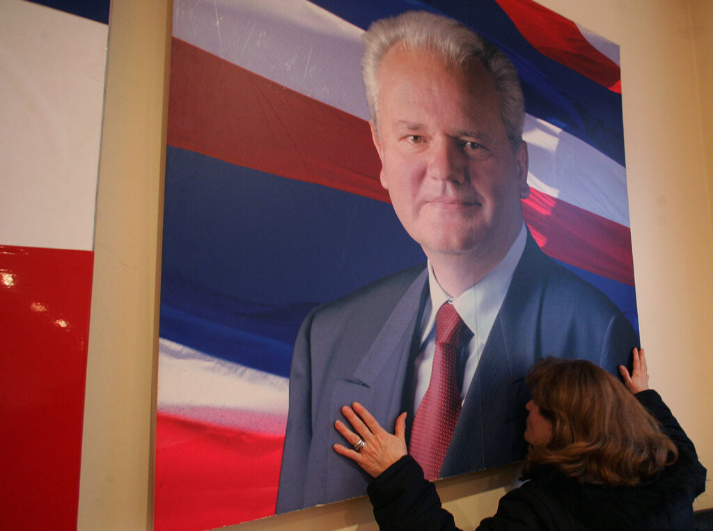 A supporter kisses a huge poster of Slobodan Milosevic in headquarters of pro-Milosevic support group "Freedom", in Belgrade, Saturday, March 11, 2006. Slobodan Milosevic, former Serbian and Yugoslav president indicted with war crimes, was found dead in his prison cell at the U.N. war crimes tribunal in The Hague,Saturday, March 11 2006, Belgrade's B-92 and Serbia's state radio said. A Serbian government official and United Nation's war crimes prosecution official in the Dutch capoital, speaking on condition of anonymity because they were not entitled to speak to the media, confirmed the report to the Associated Press. (AP Photo/Srdjan Ilic)